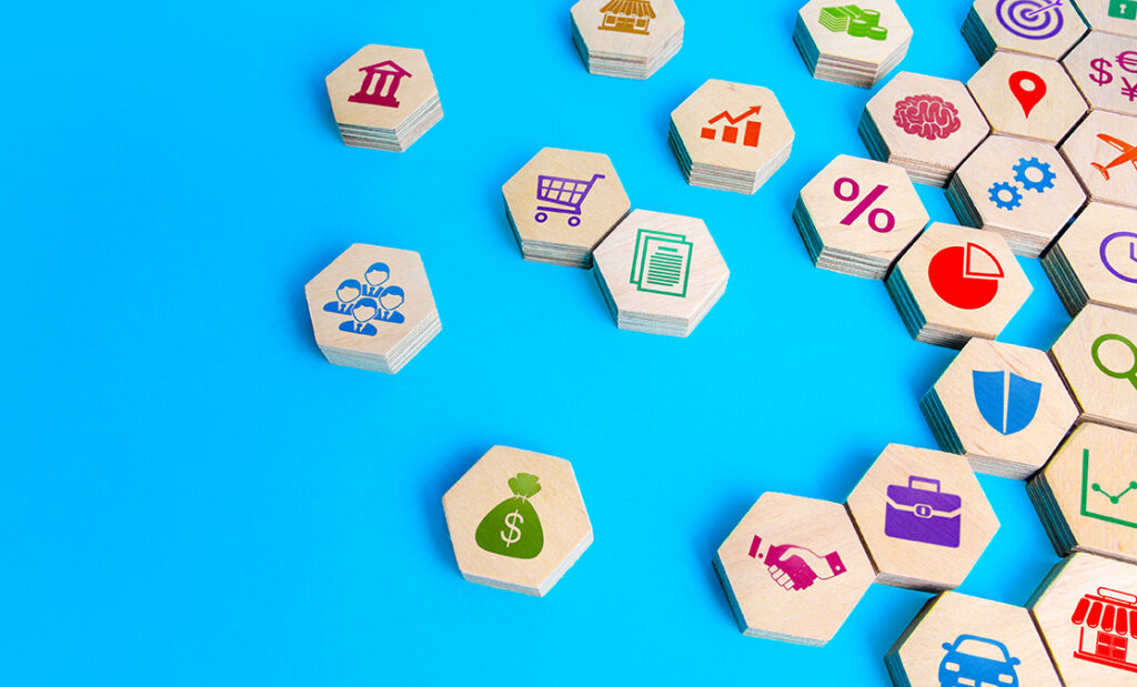 Hexagonal tiles are shown, with icons like a bag of money and a shopping cart, put together to imply they're parts of a bigger business model.